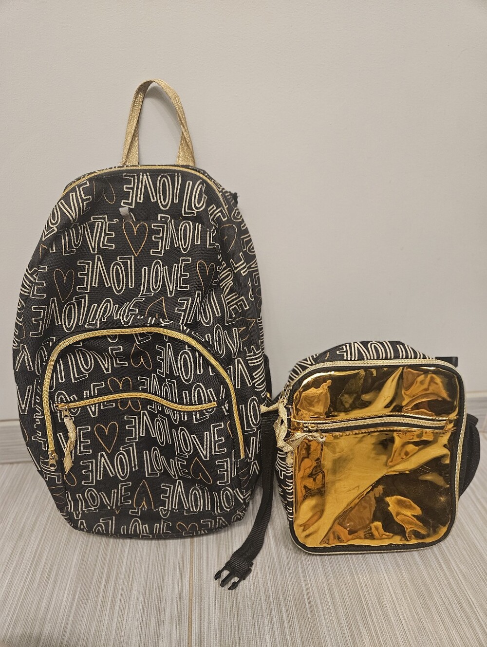 Black and gold "Love" print backpack and matching lunch bag set